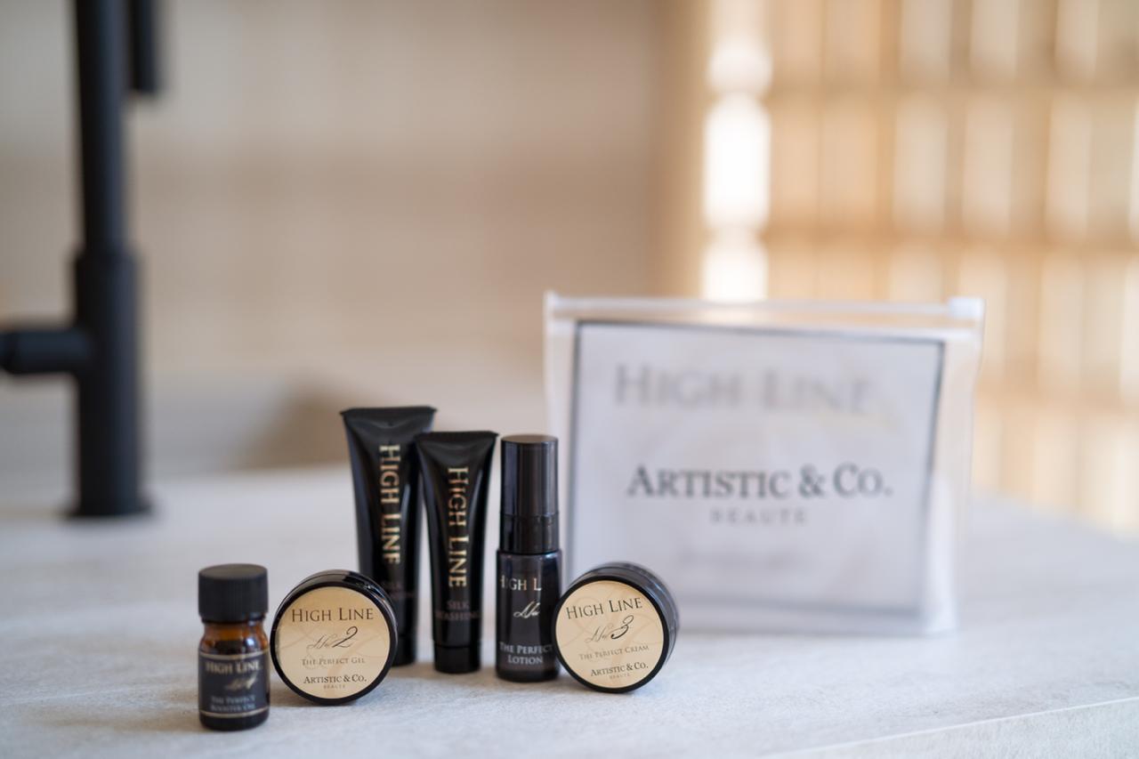 Artistic & Co. High Line professional Japanese skincare collection — face oil, cream, lotion and serum in premium black and gold packaging.